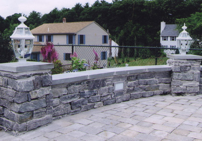 Patio composed of stone, granite and integrated lighting.
